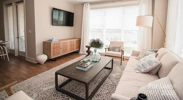 a large kitchen with stainless steel appliances granite countertop a lot of counter space and a wooden floors