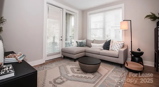 a living room with furniture a kitchen view and appliances