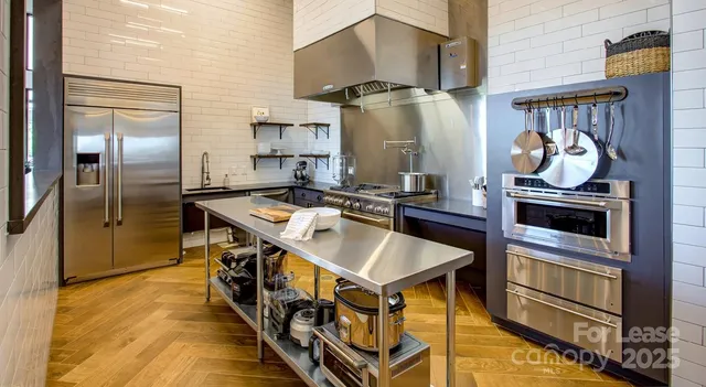 a kitchen with stainless steel appliances granite countertop a stove and a refrigerator