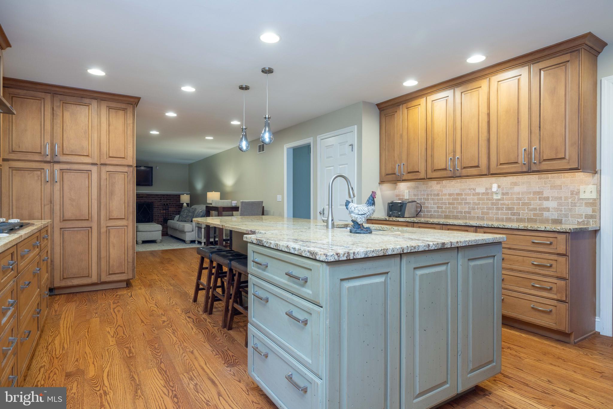 17 Bridleshire Road Newark, DE 19711 - Photo 5 of 62 a kitchen with kitchen island granite countertop wooden floors and white cabinets