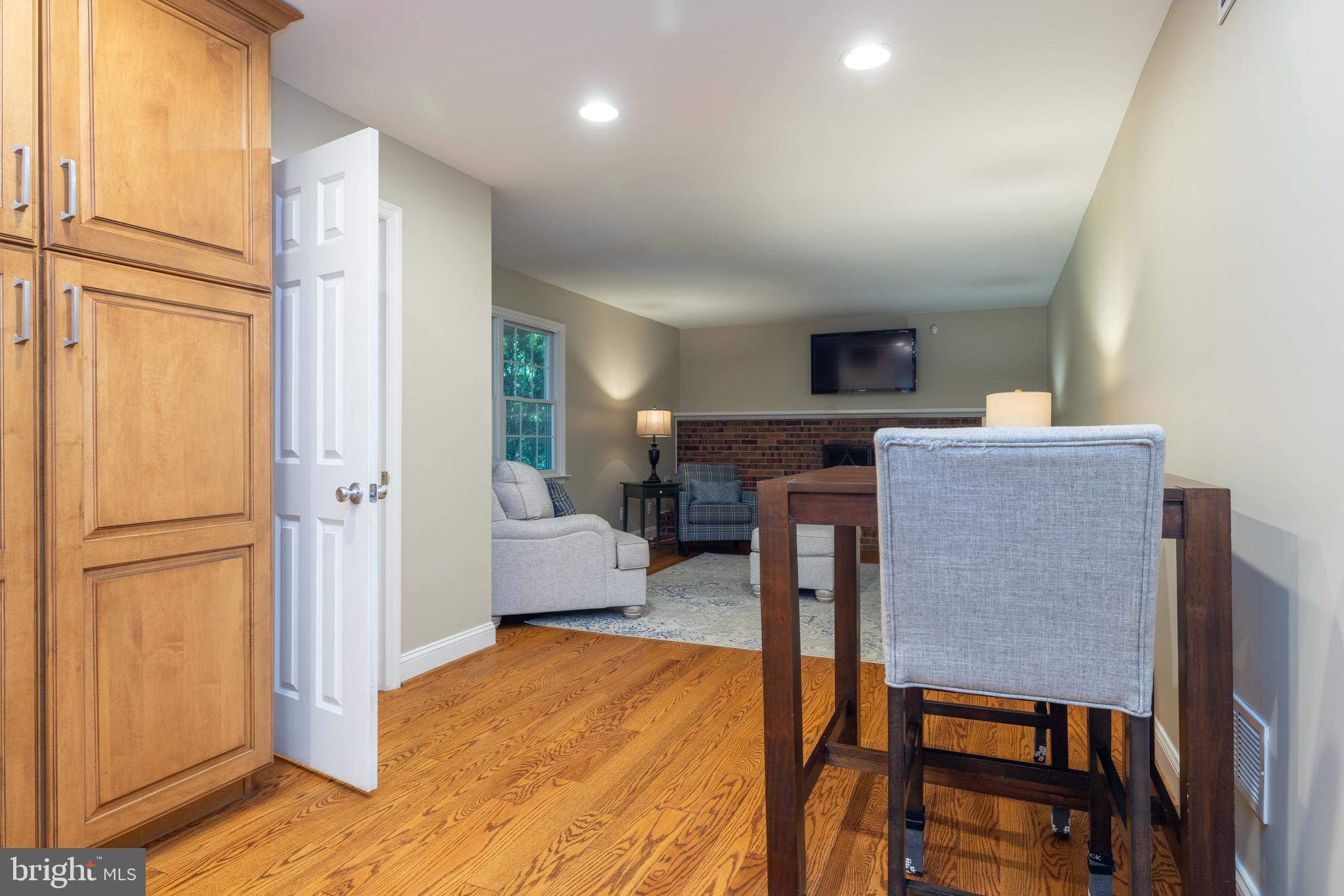 17 Bridleshire Road Newark, DE 19711 - Photo 10 of 62 a living room with furniture a flat screen tv and a refrigerator