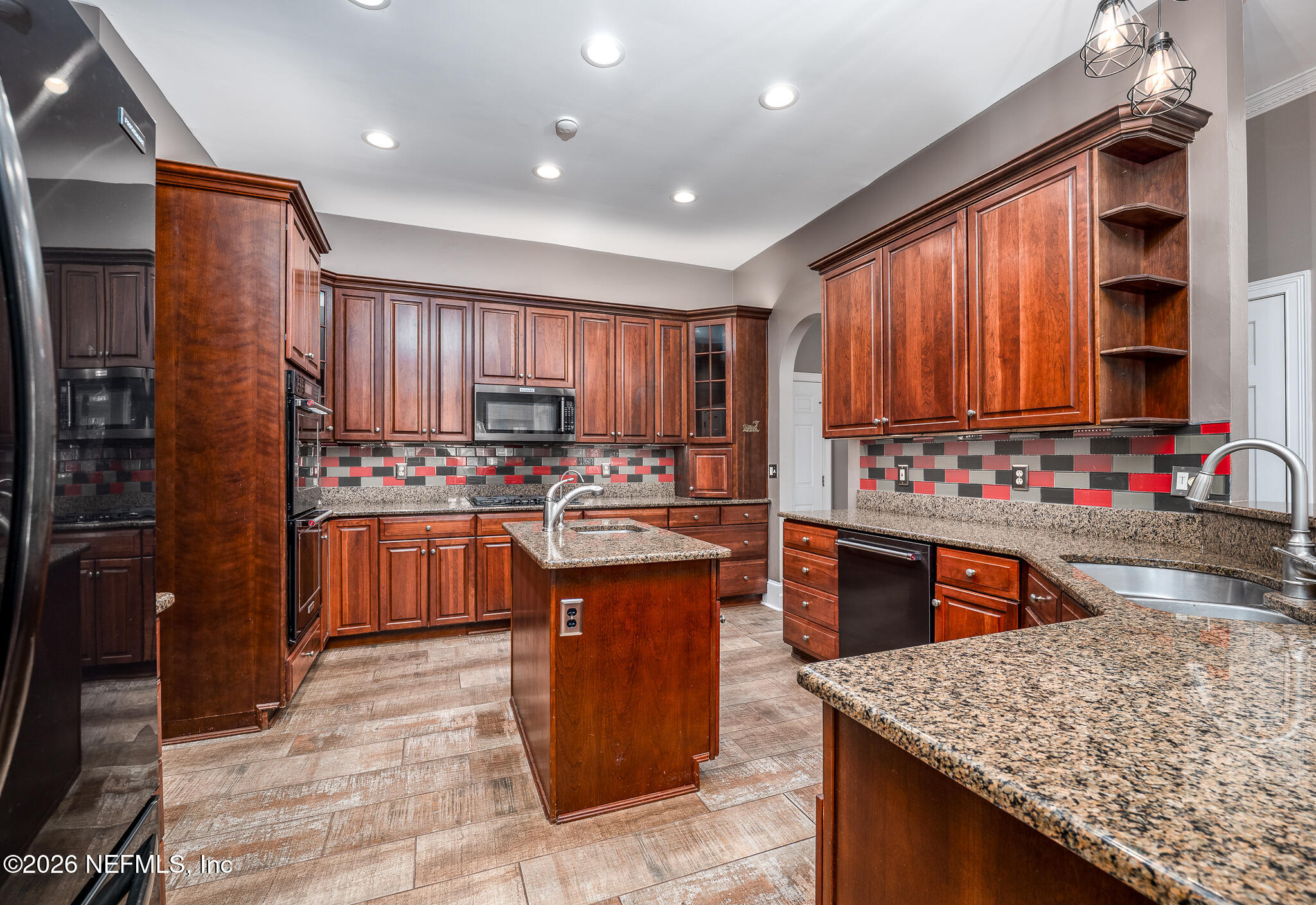 707 Standish Court St. Augustine, FL 32086 - Photo 28 of 69 a kitchen with stainless steel appliances granite countertop sink stove top oven and refrigerator