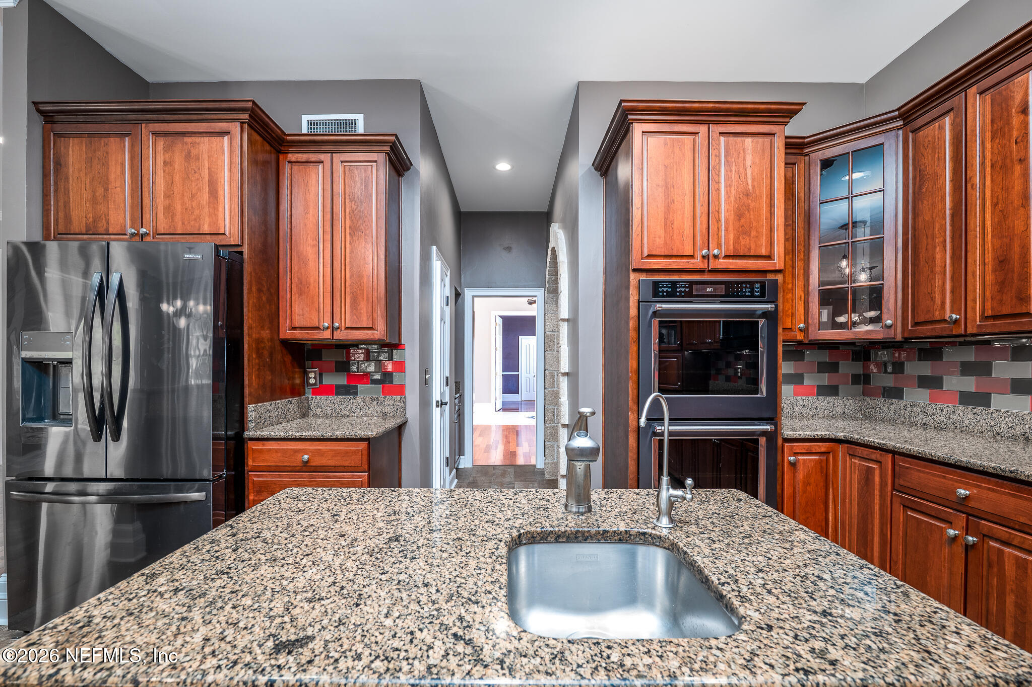 707 Standish Court St. Augustine, FL 32086 - Photo 32 of 69 a kitchen with stainless steel appliances granite countertop a refrigerator sink and cabinets