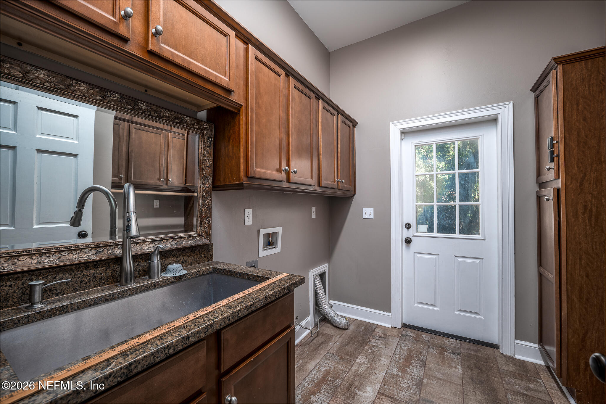 707 Standish Court St. Augustine, FL 32086 - Photo 47 of 69 a kitchen with granite countertop a sink stainless steel appliances and cabinets