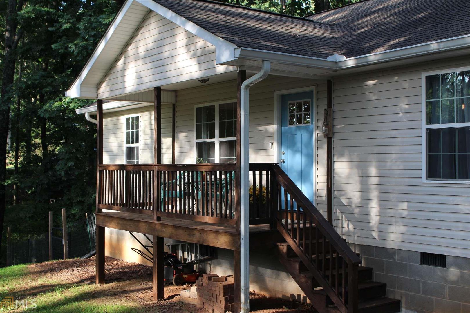 53 Windy Hills Road Cleveland, GA 30528 - Photo 1 of 1 a view of a house with wooden deck