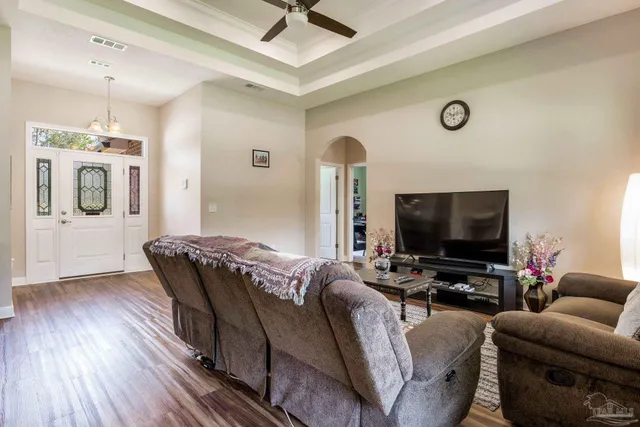 a living room with furniture and a wooden floor