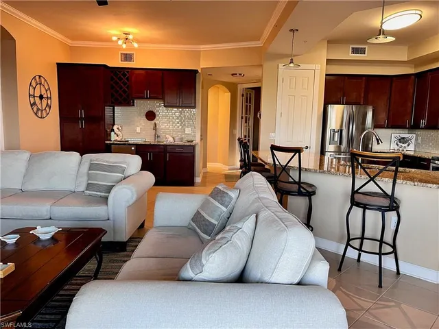 a living room with furniture and a lamp