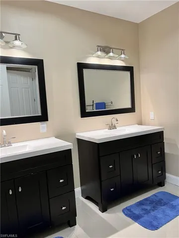 a bathroom with a sink vanity and mirror