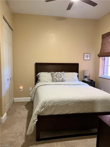 a bedroom with a bed and painting on the wall