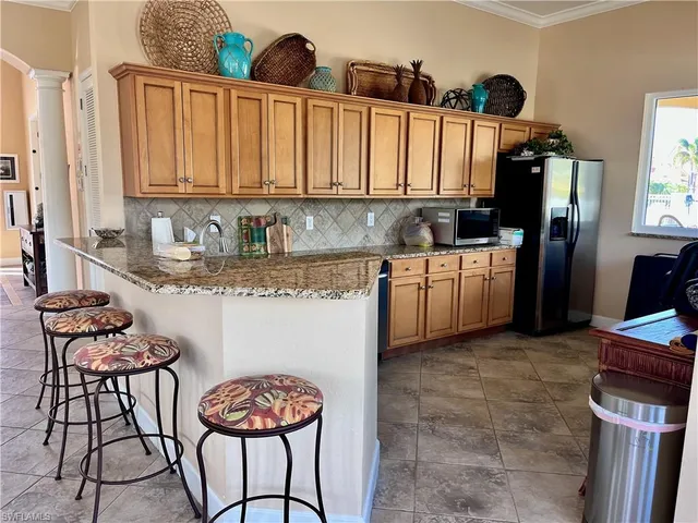 a kitchen with stainless steel appliances granite countertop a sink and cabinets