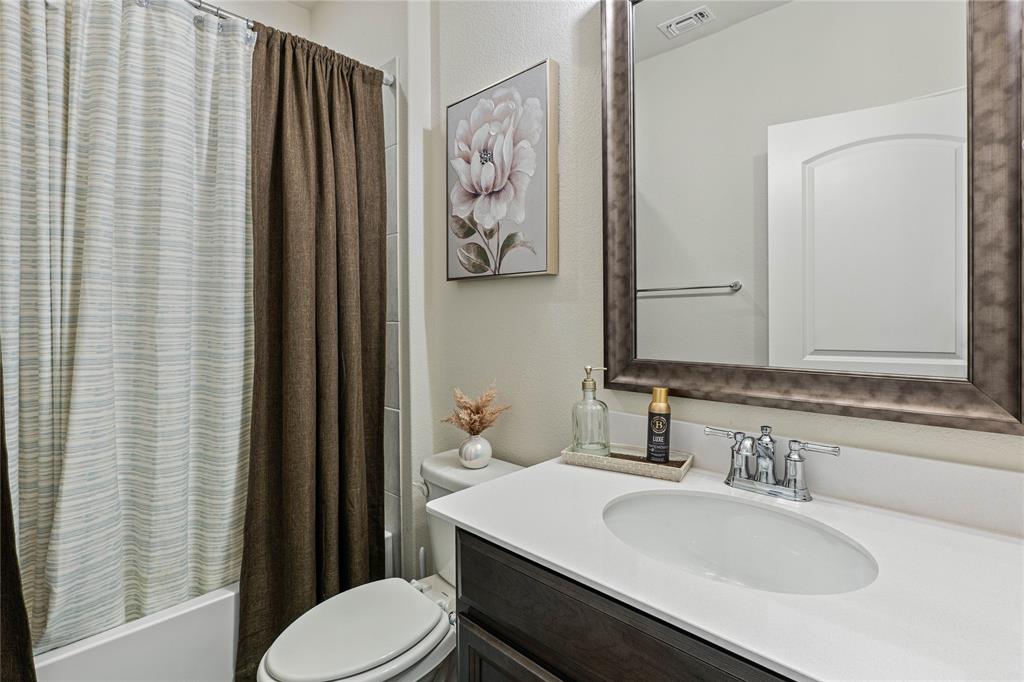 9517 Sunset Lane Oak Point, TX 75068 - Photo 7 of 40 9517 Sunset Lane, Oak Point, TX 75068 - bathrooom - Full bath featuring vanity, shower / bath combination with curtain, and a textured wall