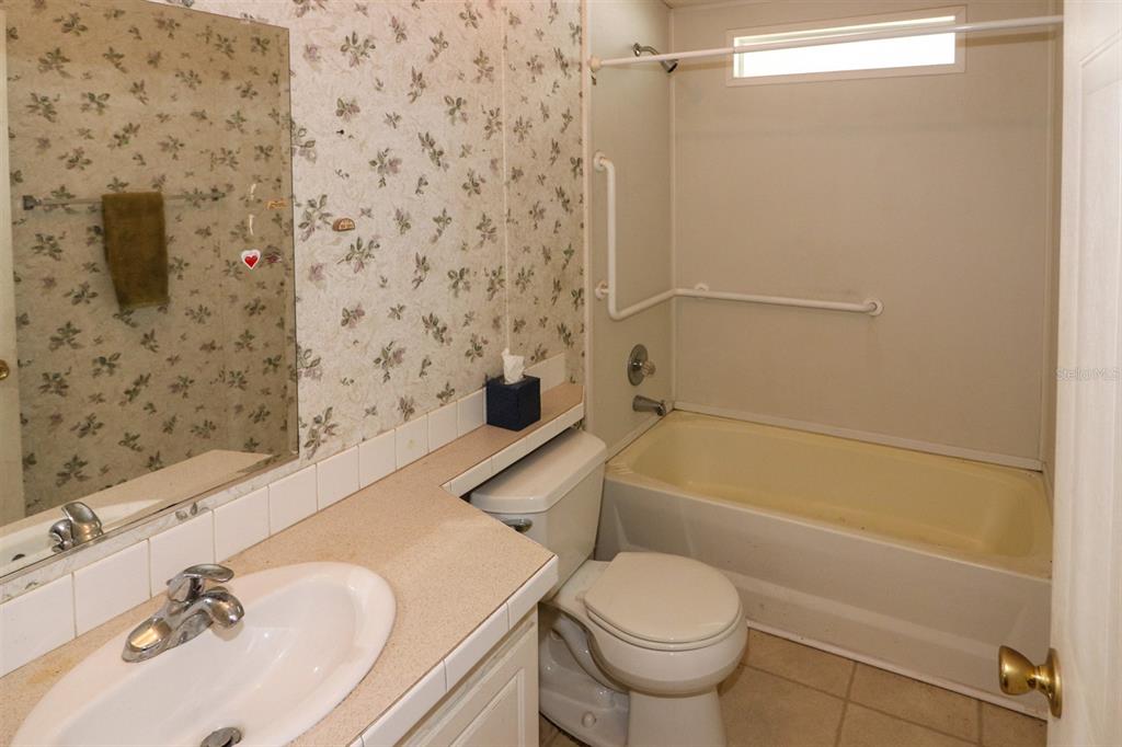29200 South Jones Loop Road, Unit 205 Punta Gorda, FL 33950 - Photo 13 of 25 a bathroom with a sink toilet and shower
