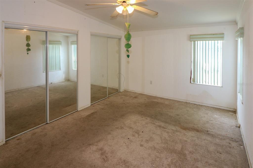 29200 South Jones Loop Road, Unit 205 Punta Gorda, FL 33950 - Photo 15 of 25 an empty room with fan and windows