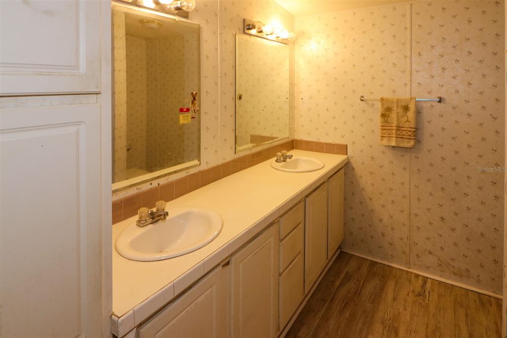 29200 South Jones Loop Road, Unit 205 Punta Gorda, FL 33950 - Photo 17 of 25 a bathroom with a sink and a mirror