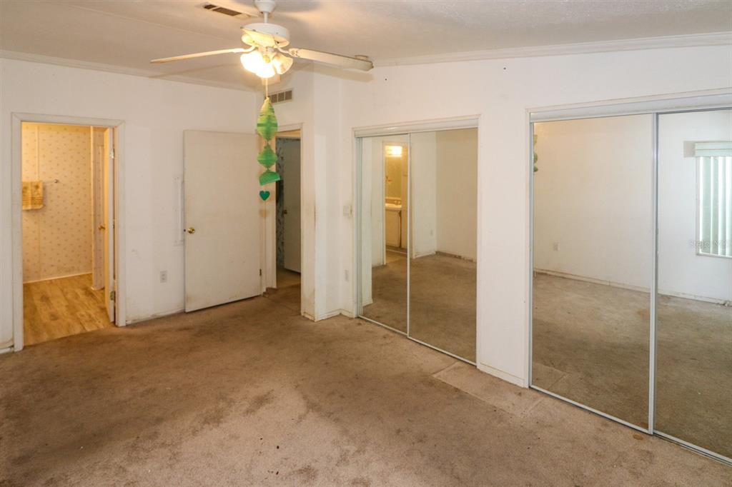 29200 South Jones Loop Road, Unit 205 Punta Gorda, FL 33950 - Photo 20 of 25 an empty room with fan and entrance
