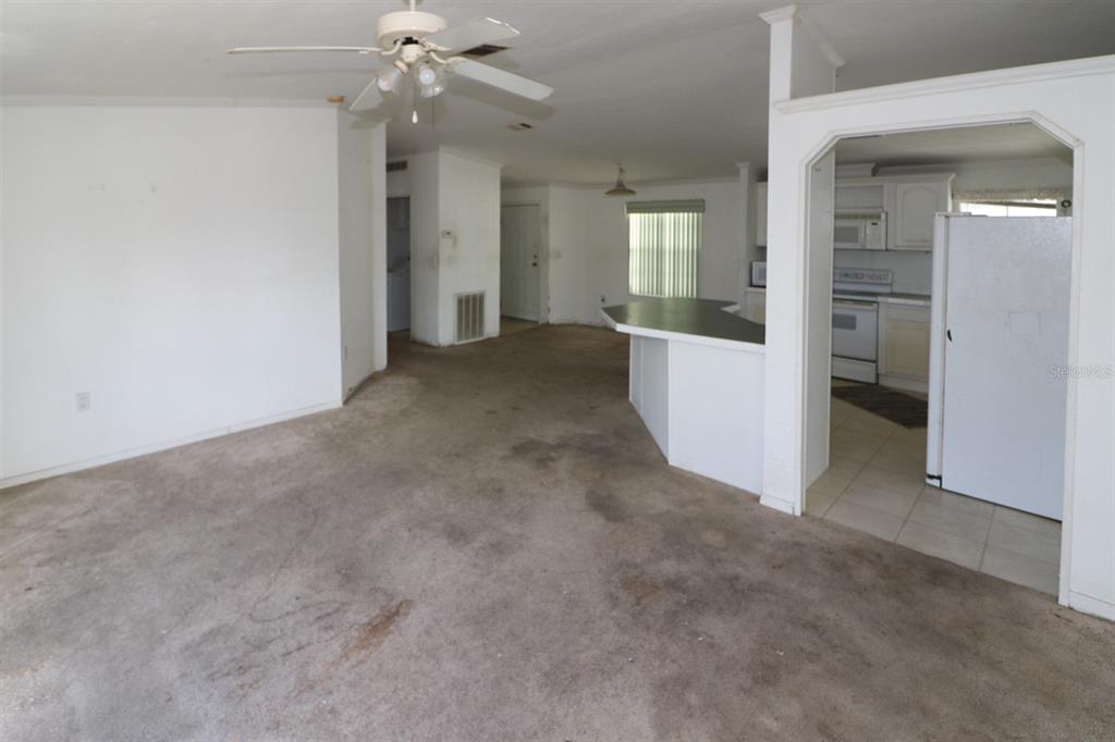 29200 South Jones Loop Road, Unit 205 Punta Gorda, FL 33950 - Photo 4 of 25 a view of a room with an empty space and a kitchen