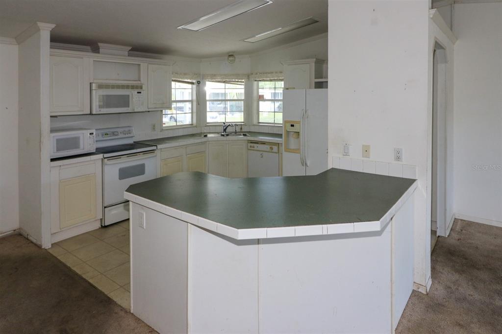 29200 South Jones Loop Road, Unit 205 Punta Gorda, FL 33950 - Photo 6 of 25 a view of a kitchen counter space with wooden floor