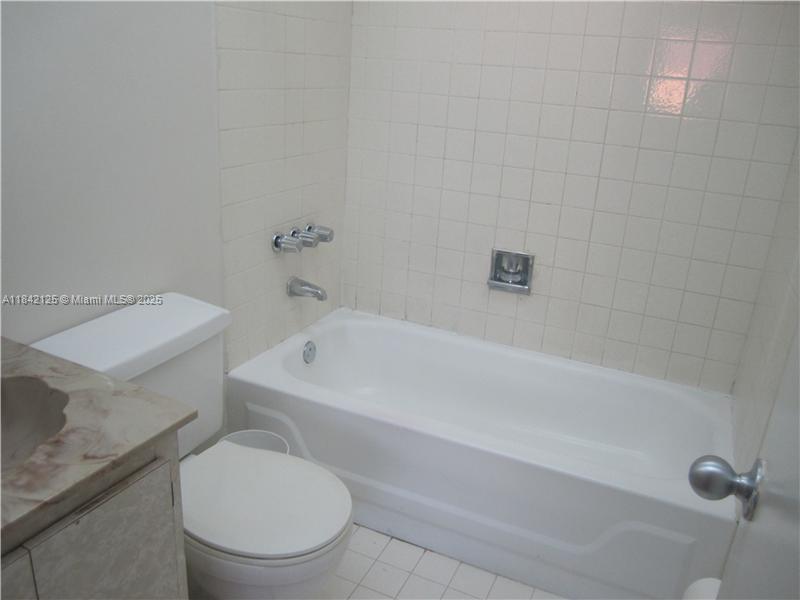 1121 Southwest 105th Avenue, Unit 322 Miami, FL 33174 - Photo 12 of 19 a white toilet sitting next to a bath tub