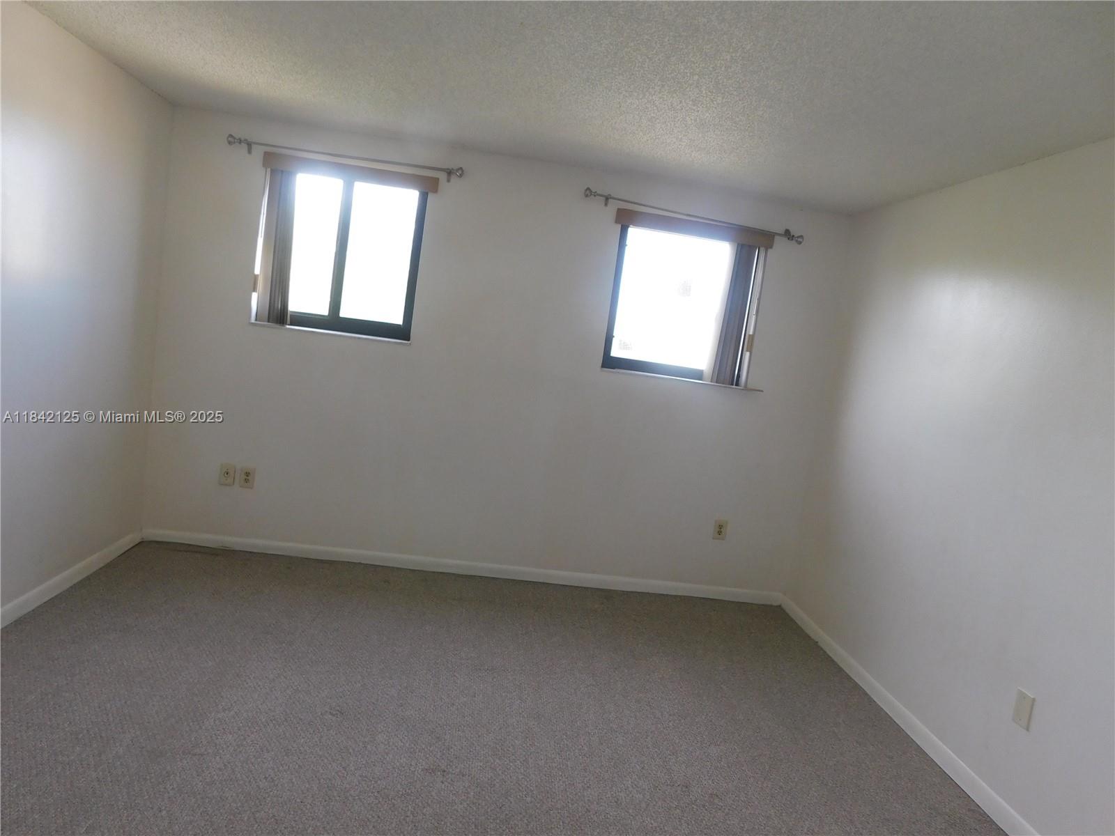 1121 Southwest 105th Avenue, Unit 322 Miami, FL 33174 - Photo 13 of 19 an empty room with a window