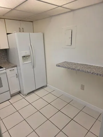 a view of a storage & utility room with cabinets