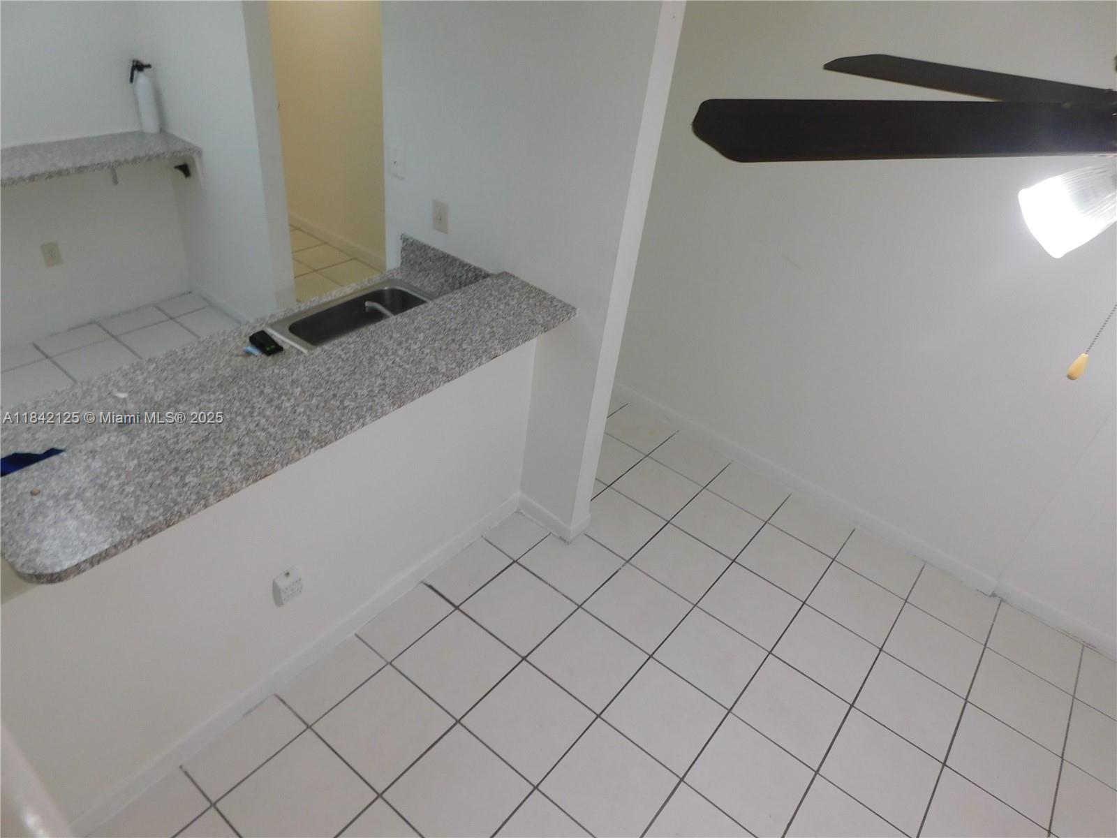 1121 Southwest 105th Avenue, Unit 322 Miami, FL 33174 - Photo 3 of 19 a bathroom with a granite countertop sink and mirror