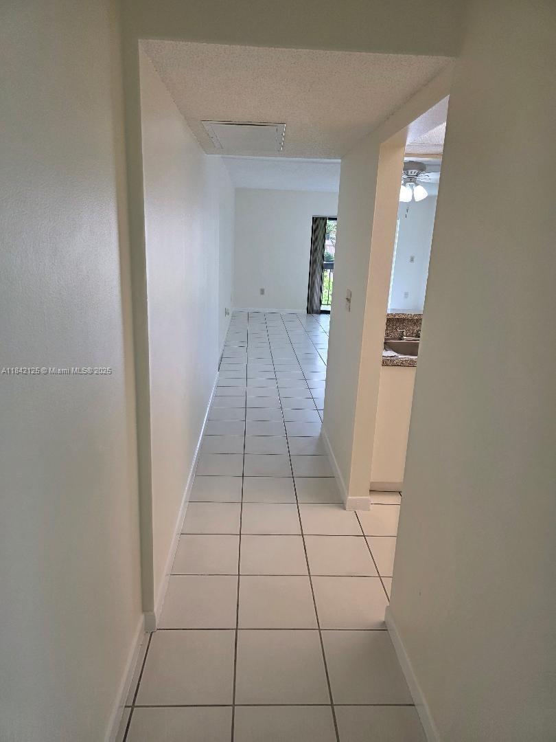 1121 Southwest 105th Avenue, Unit 322 Miami, FL 33174 - Photo 5 of 19 a view of a bathroom with a sink and a mirror