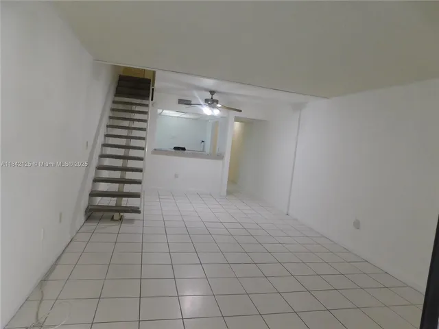 a view of an empty room with stairs