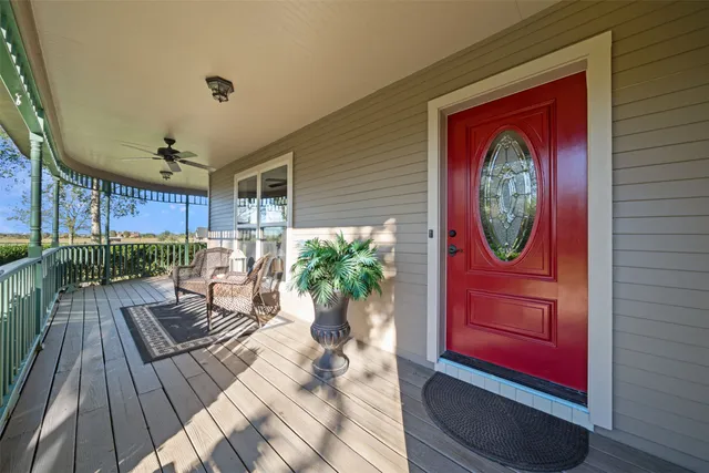 a dining hall with stainless steel appliances kitchen island granite countertop a table chairs and a view of living room