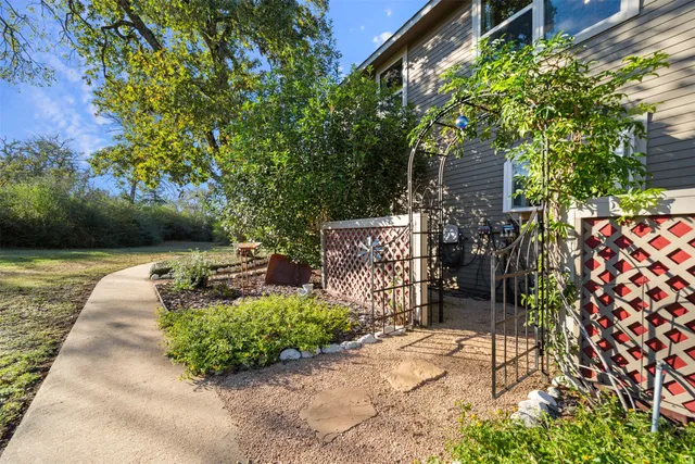 a large kitchen with kitchen island a large counter space wooden floor and stainless steel appliances