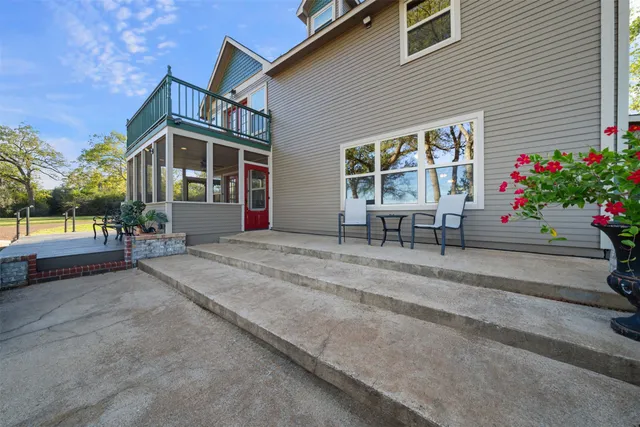 a kitchen with a stove a sink a dining table and chairs with wooden floor