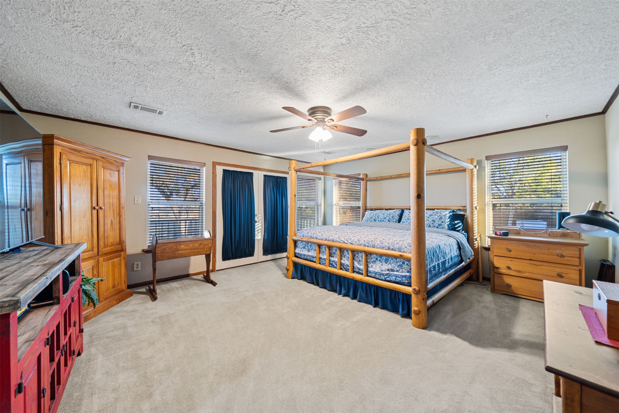 25948 Nelson Road Hempstead, TX 77445 - Photo 21 of 50 a bedroom with a bed and a chandelier
