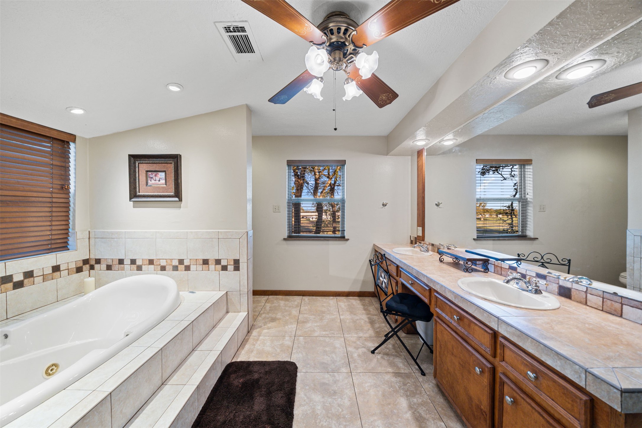 25948 Nelson Road Hempstead, TX 77445 - Photo 24 of 50 a spacious bathroom with a double vanity sink a mirror and a bathtub