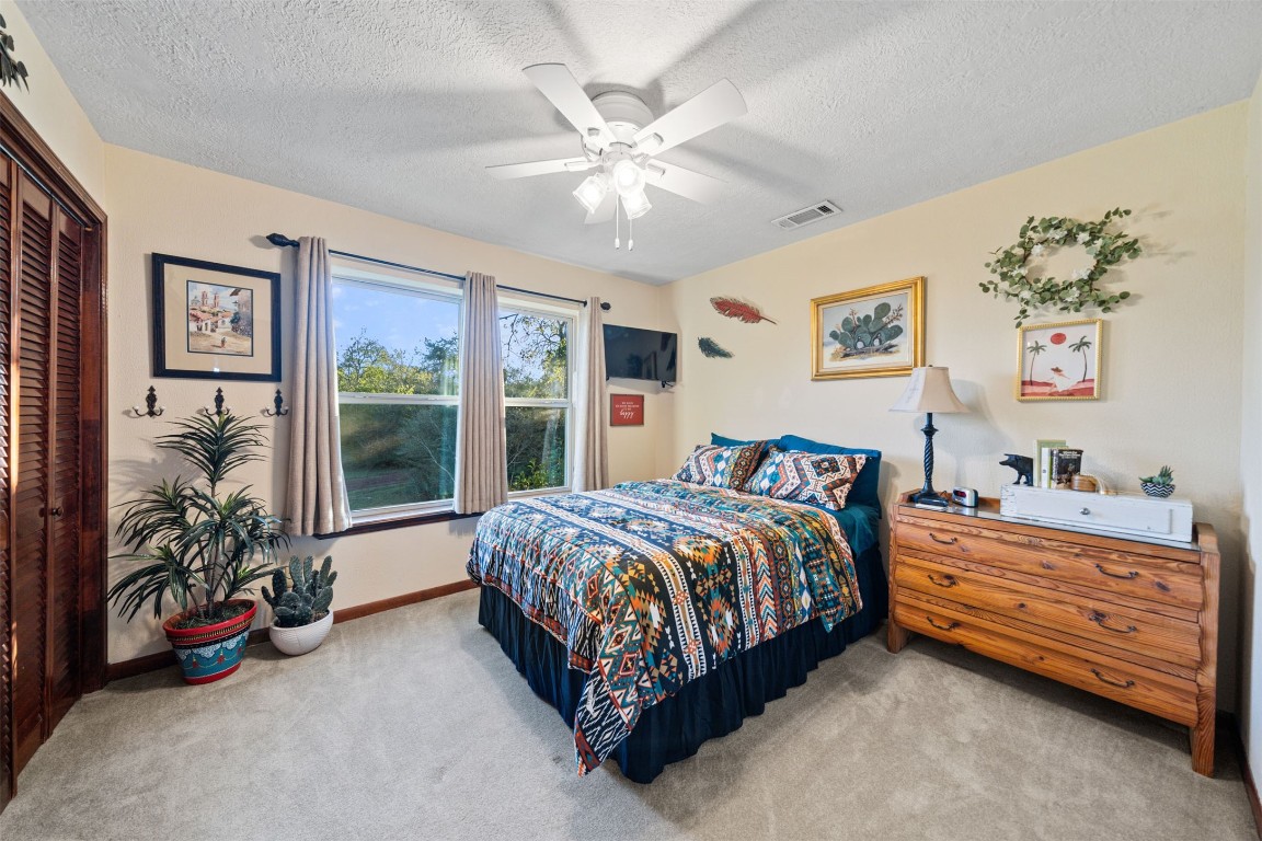 25948 Nelson Road Hempstead, TX 77445 - Photo 28 of 50 a bed room with a bed and a chandelier