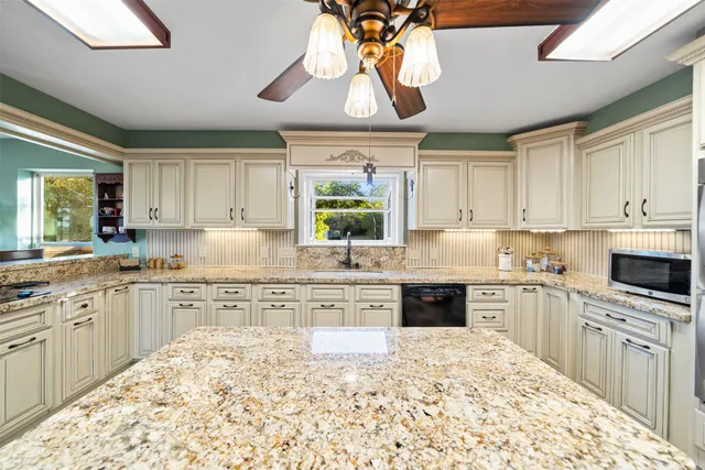 a view of a kitchen with workspace and furniture