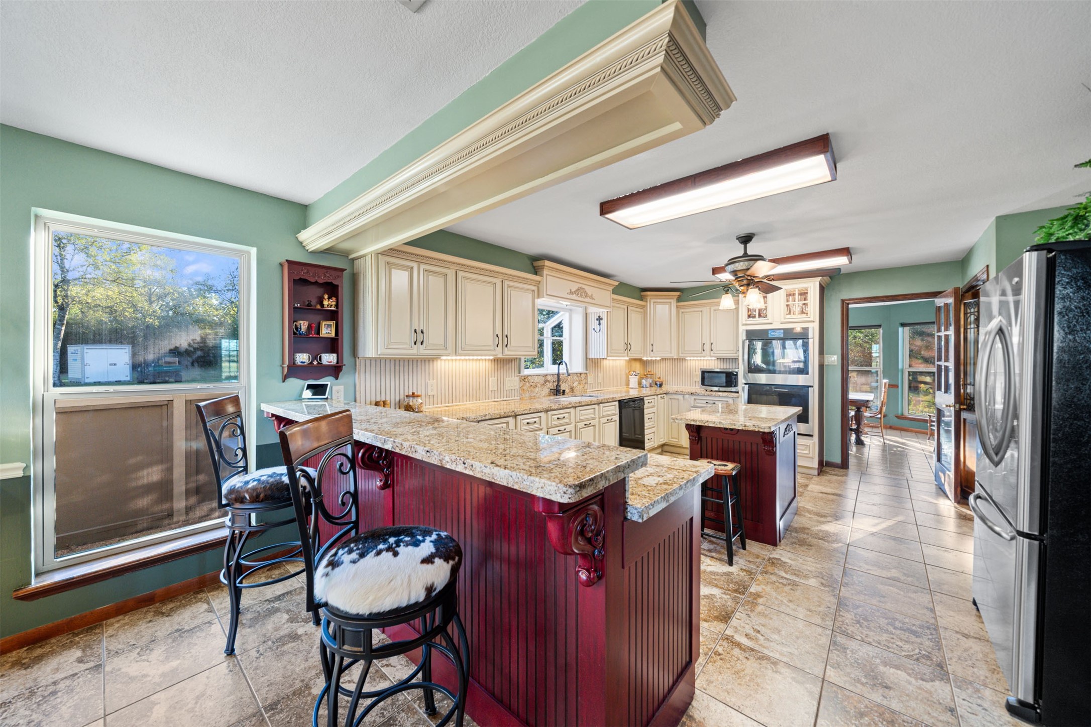 25948 Nelson Road Hempstead, TX 77445 - Photo 4 of 50 a dining hall with stainless steel appliances kitchen island granite countertop a table chairs and a view of living room