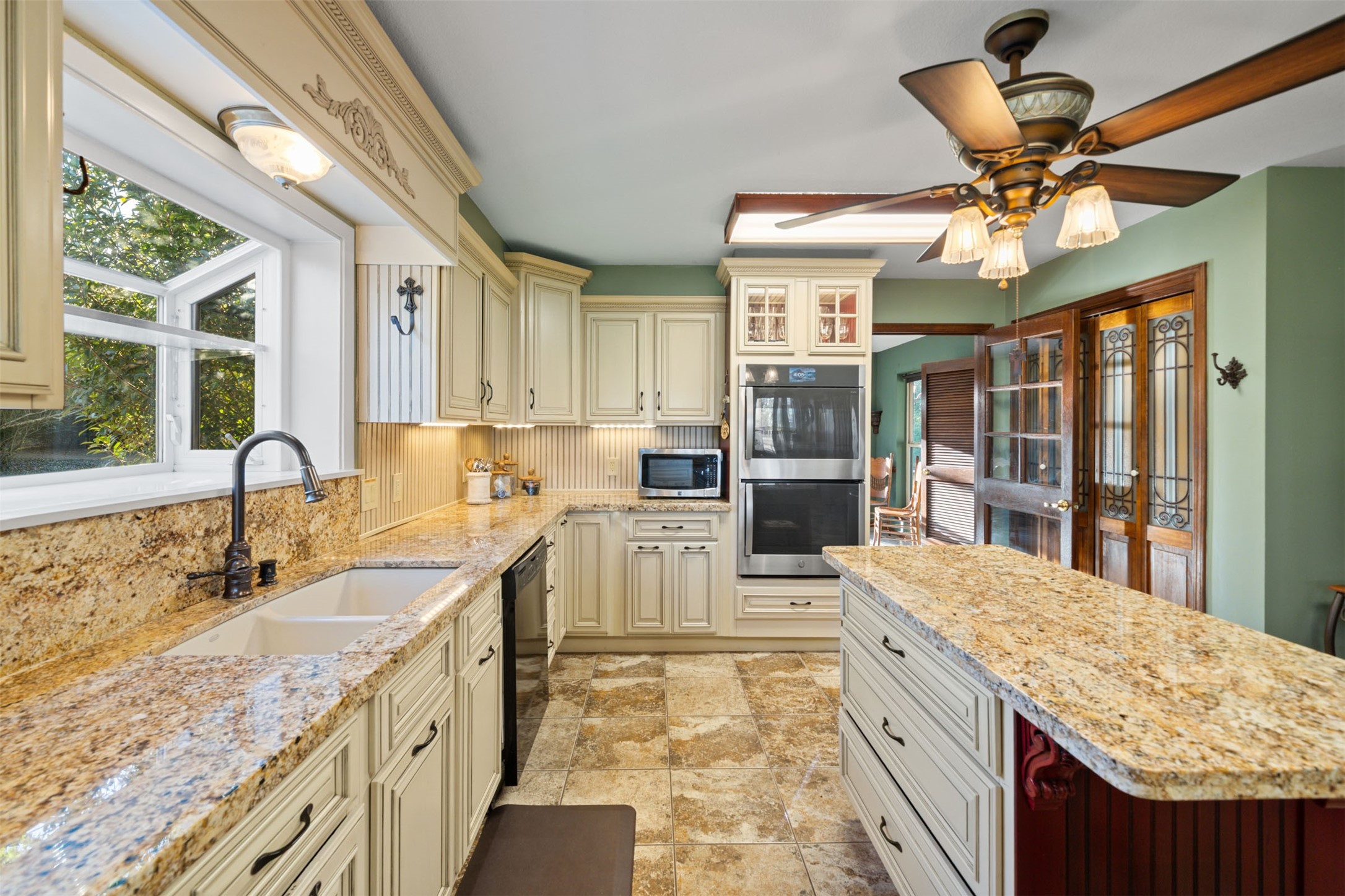 25948 Nelson Road Hempstead, TX 77445 - Photo 7 of 50 a large kitchen with kitchen island a large counter space wooden floor and stainless steel appliances