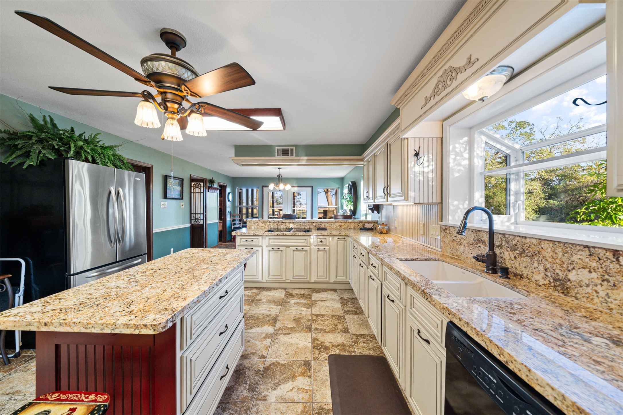 25948 Nelson Road Hempstead, TX 77445 - Photo 9 of 50 a large kitchen with kitchen island a large counter space wooden floor and stainless steel appliances