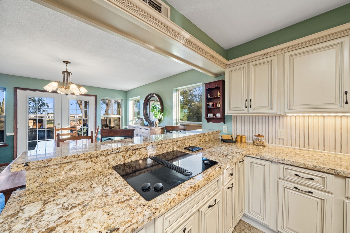 25948 Nelson Road Hempstead, TX 77445 - Photo 10 of 50 a kitchen with a stove a sink a refrigerator and cabinets