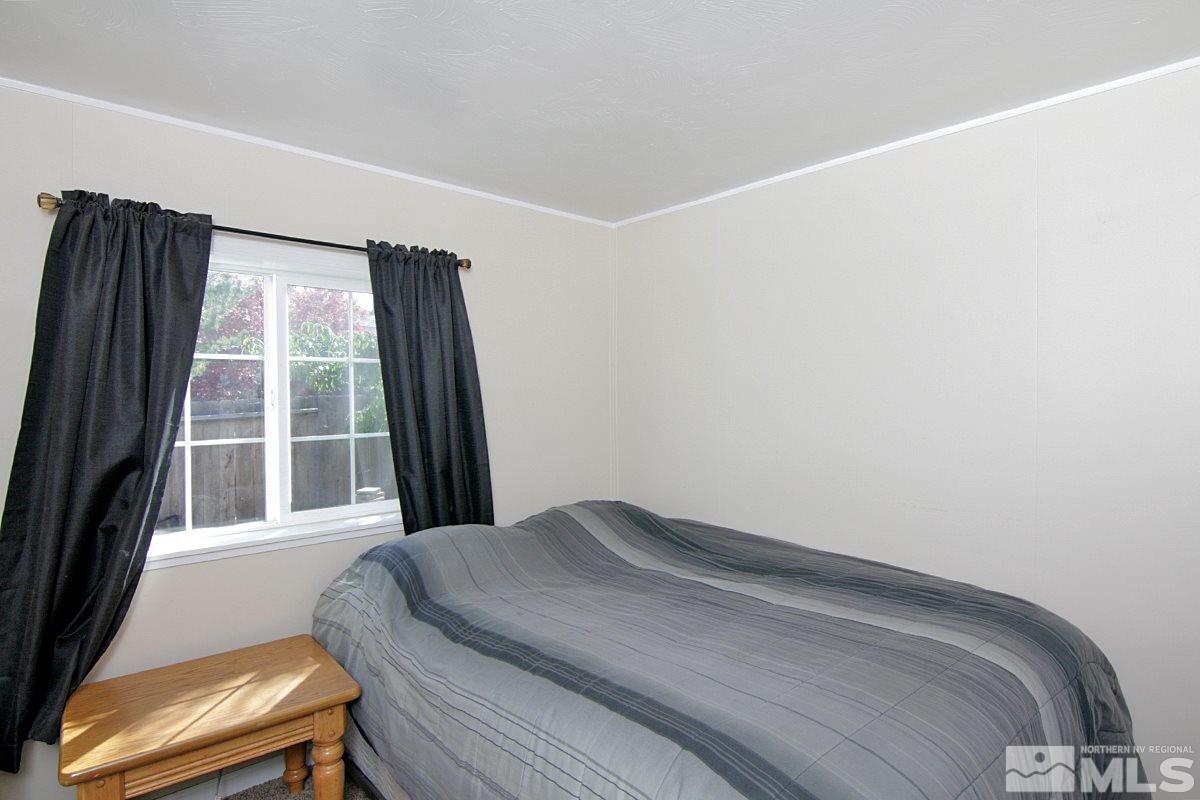 17230 Touraco Street Reno, NV 89508 - Photo 9 of 21 a bedroom with a bed and a window with outer view