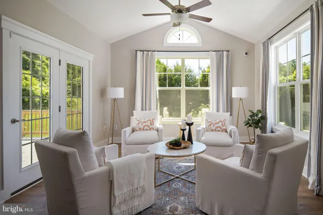 a dining room with furniture a chandelier and wooden floor