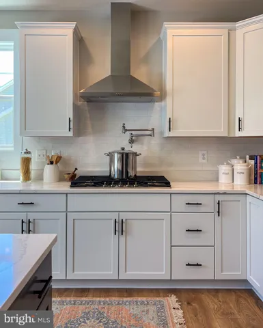 a kitchen with stainless steel appliances granite countertop a refrigerator stove microwave and sink