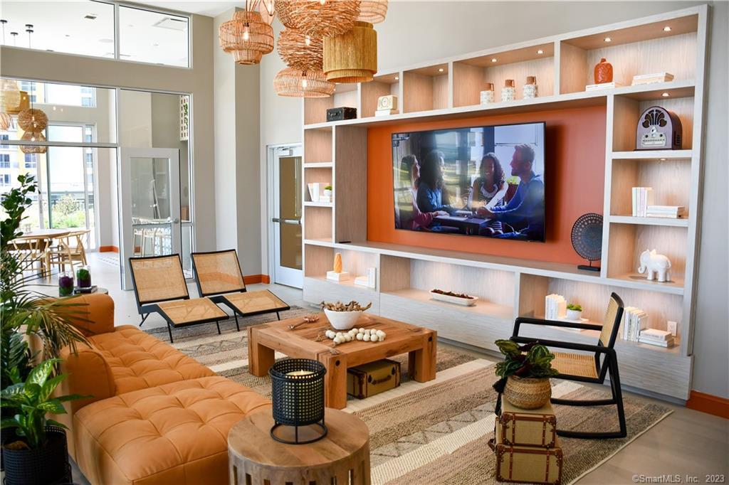a living room with furniture a rug and a window