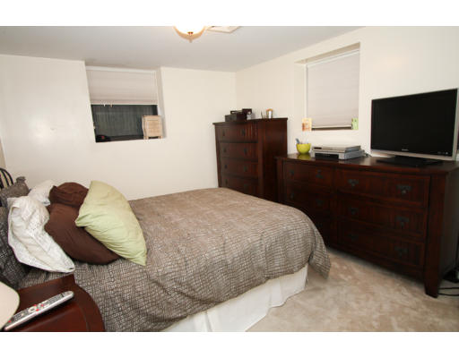 10 Beacon Street, Unit 1 Chelsea, MA 02150 - Photo 11 of 17 a bedroom with a bed and flat screen tv