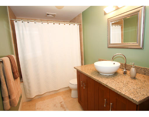 10 Beacon Street, Unit 1 Chelsea, MA 02150 - Photo 12 of 17 a bathroom with a granite countertop sink and a mirror
