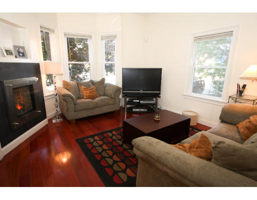 10 Beacon Street, Unit 1 Chelsea, MA 02150 - Photo 3 of 17 a living room with furniture and a flat screen tv