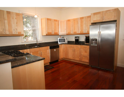 10 Beacon Street, Unit 1 Chelsea, MA 02150 - Photo 4 of 17 a kitchen with stainless steel appliances granite countertop a stove a sink and a refrigerator