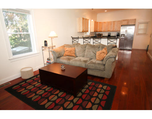10 Beacon Street, Unit 1 Chelsea, MA 02150 - Photo 9 of 17 a living room with furniture and a large window