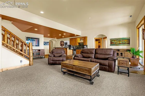a living room with furniture and a potted plant