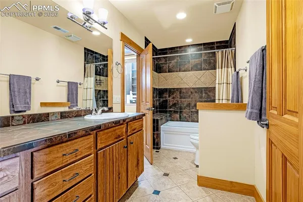 a large white kitchen with a large window