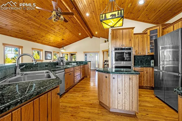 a kitchen with stainless steel appliances granite countertop a sink and cabinets